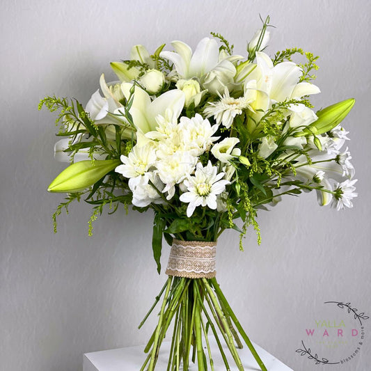 Bouquet of white flowers with greenery on a gray background