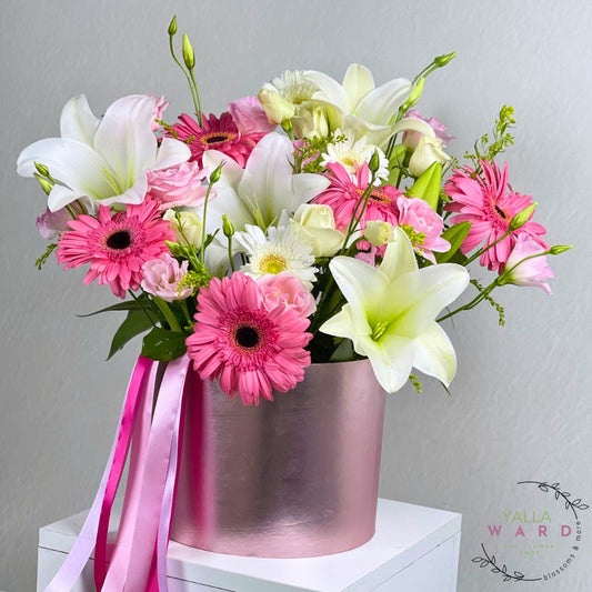 flowers with pink and white colors in a metallic container on a gray background.