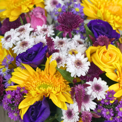 Bouquet of colorful flowers including yellow, purple, and white.