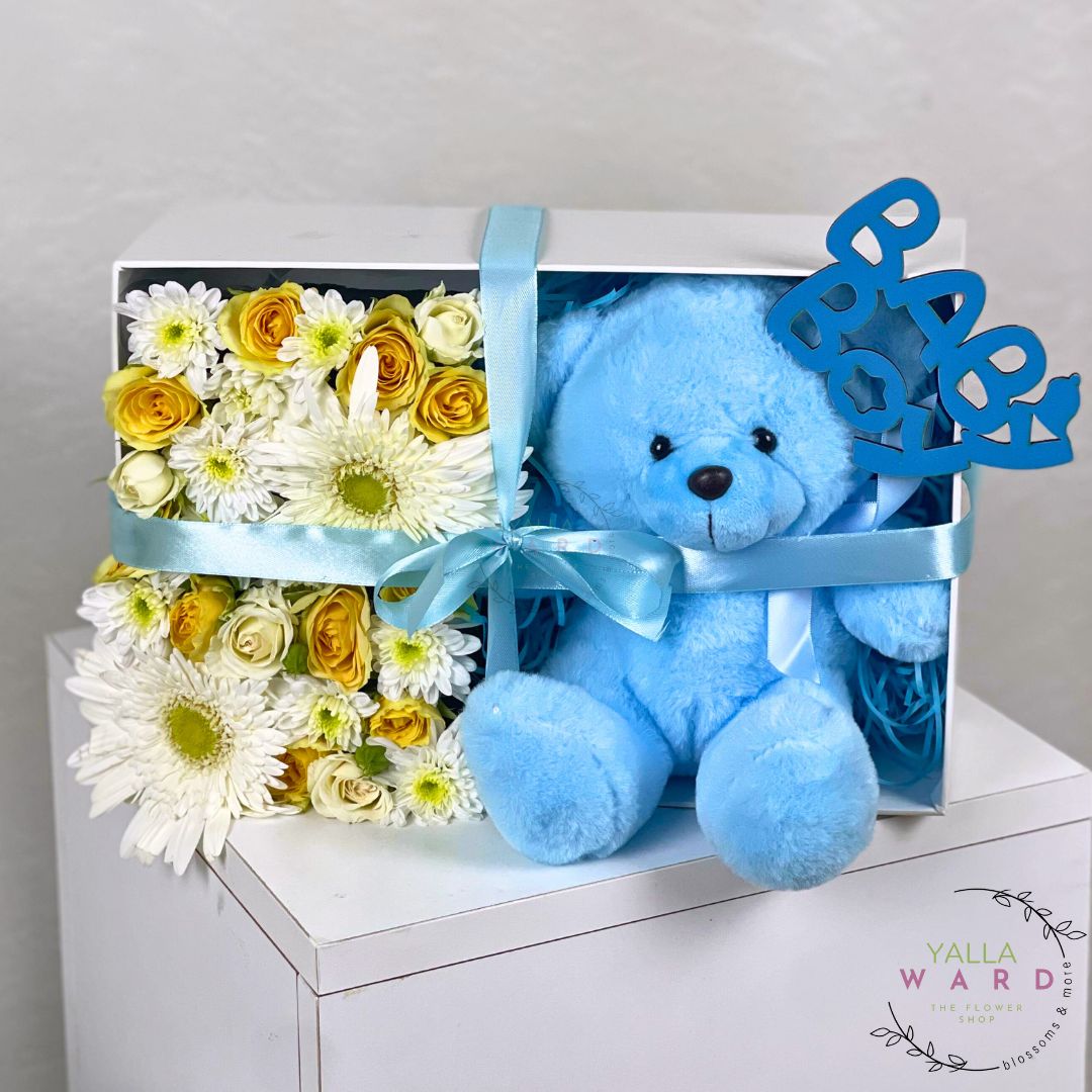 Blue teddy bear and flower arrangement in a box with 'Baby' sign, Yalla Ward brand visible