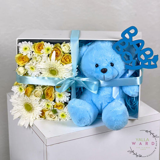 Blue teddy bear and flower arrangement in a box with 'Baby' sign, Yalla Ward brand visible