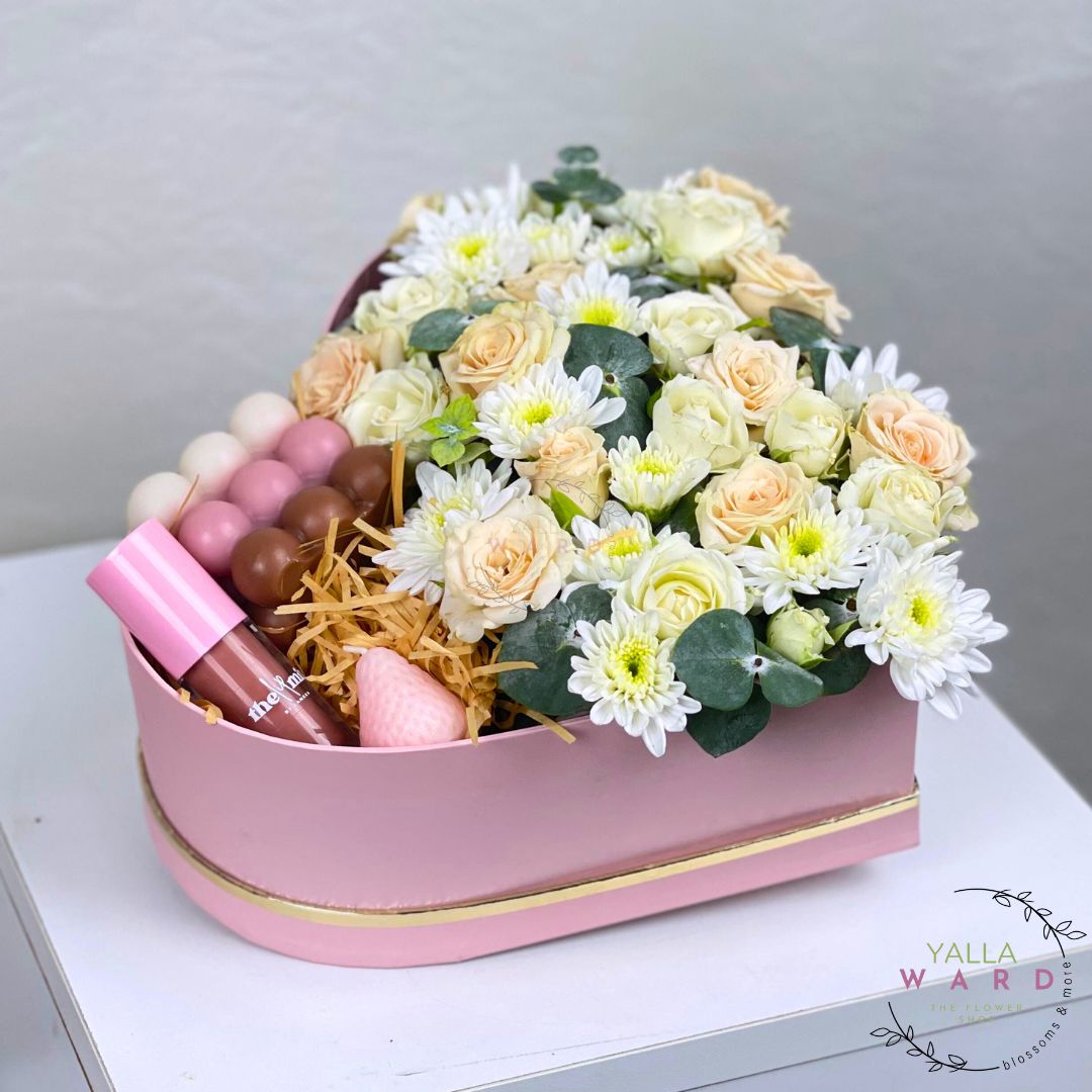 Pink box with flowers and lip products on a white surface, branded 'Yalla Ward'.
