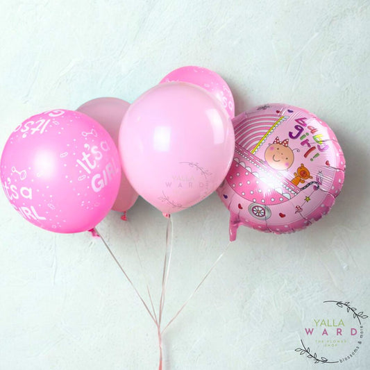 Pink balloons with baby-themed designs on a light background