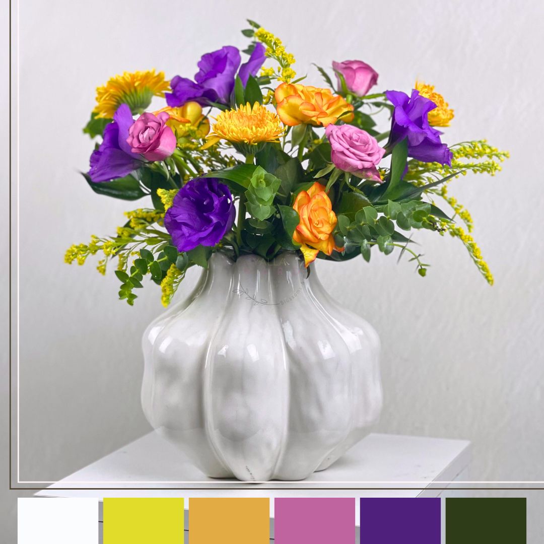 White vase with colorful flowers on a white background