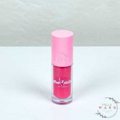 Pink lip gloss with a pink cap on a white background