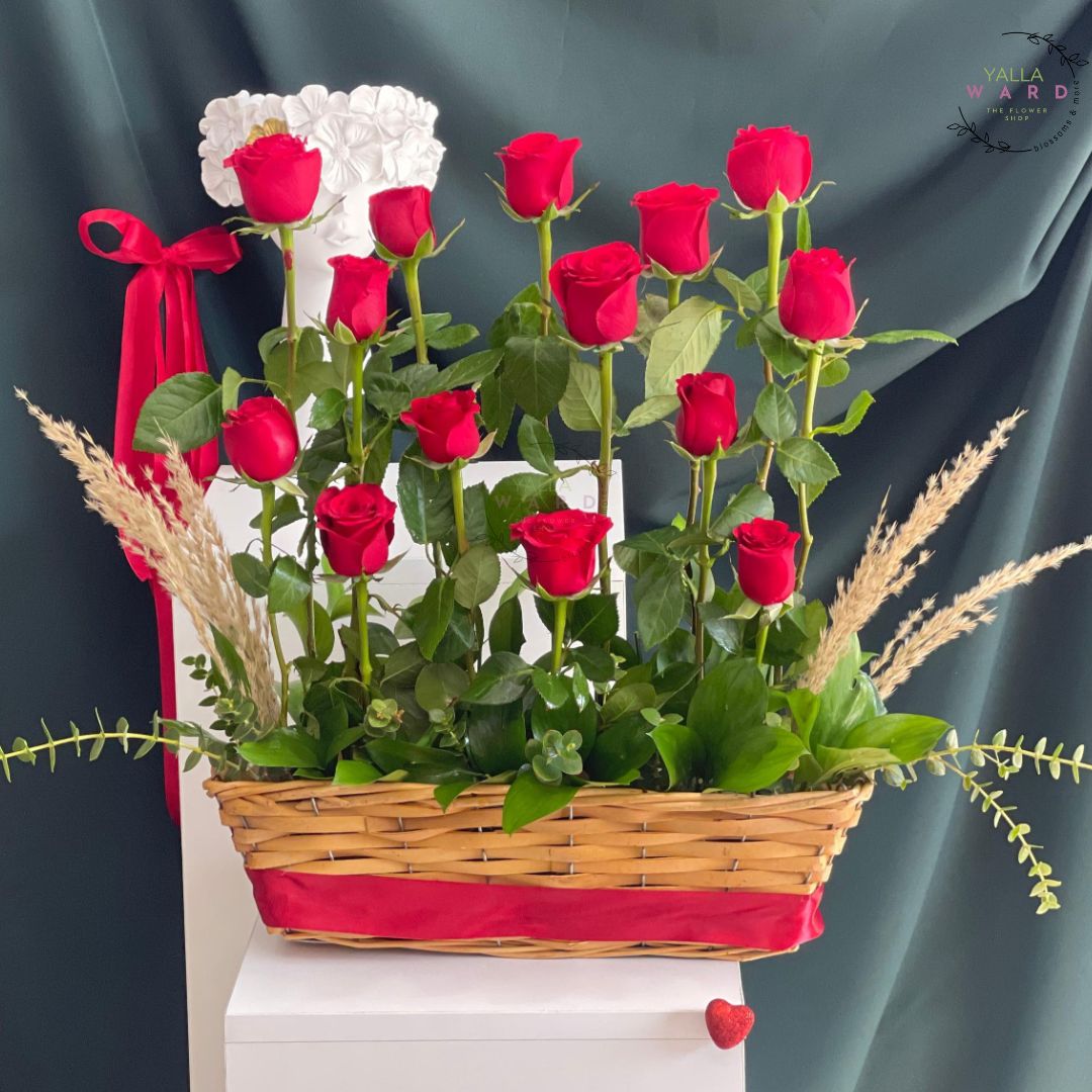 Basket of red roses with a decorative bow on a dark background