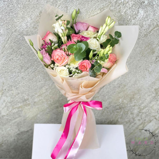 Bouquet of flowers with a pink ribbon on a textured gray background